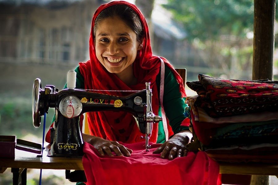 Woman working at a sewing machine as part of skills development